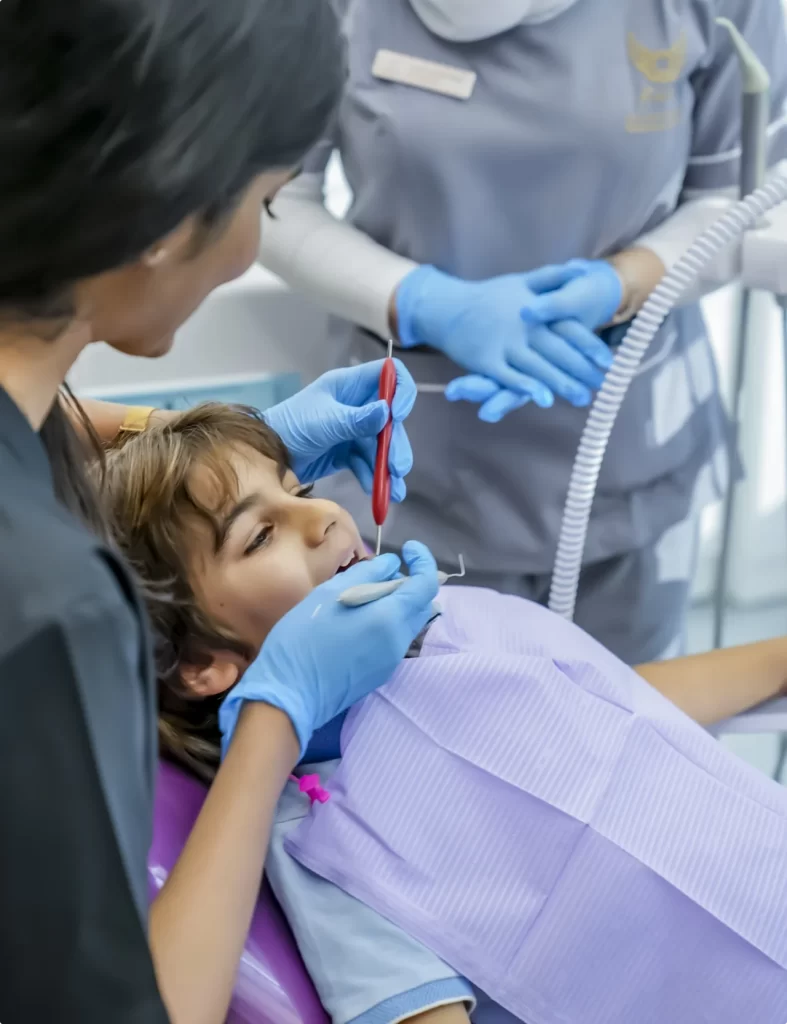 A child undergoing dental procedure to ensure a healthy and happy smile